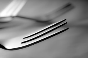 Close up image of a dessert fork made from stainless steel, an example of electroplating in daily life.